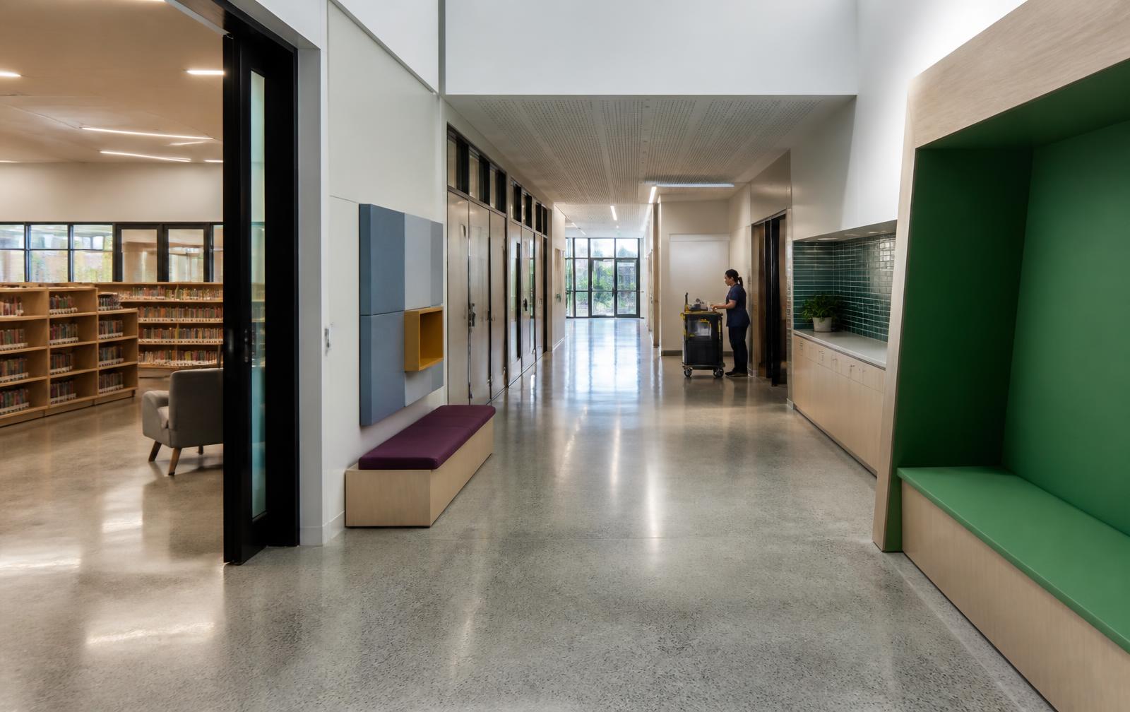 Contemporary education facility corridor and library prepared after classes